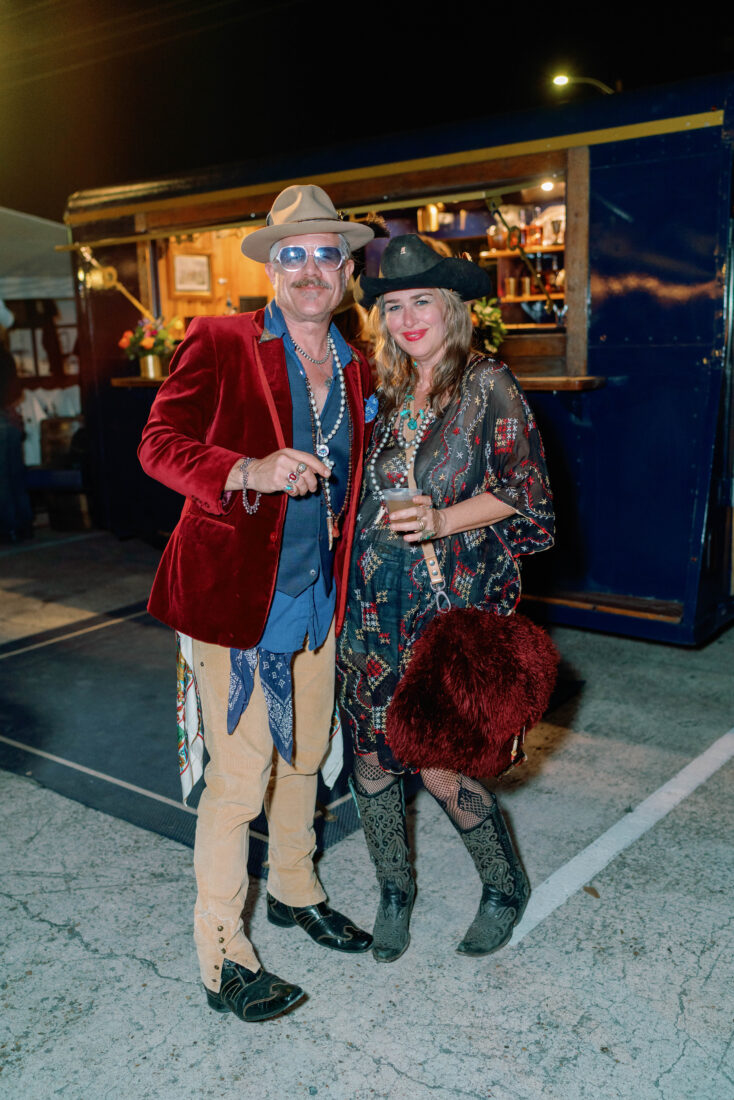Guests grab libations dressed in their Western wear finest.