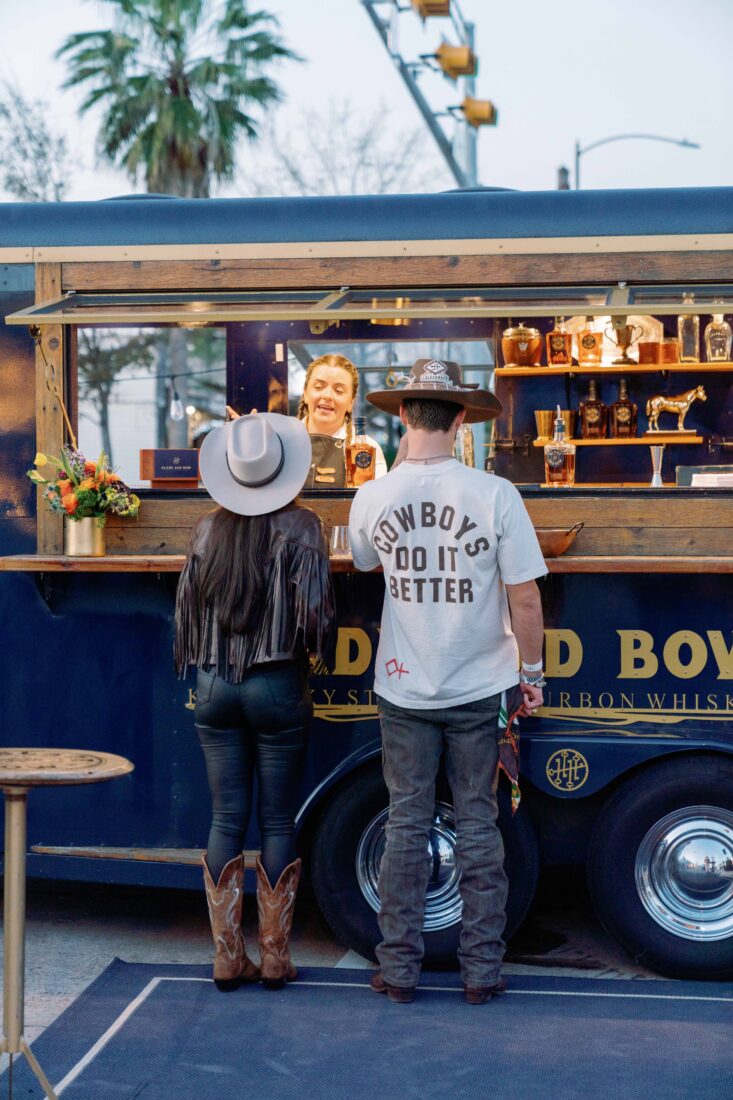 The expertly crafted Rodeo Smoke Show cocktails are served at Blade and Bow’s custom horse trailer bar—offering a mobile mixology experience.