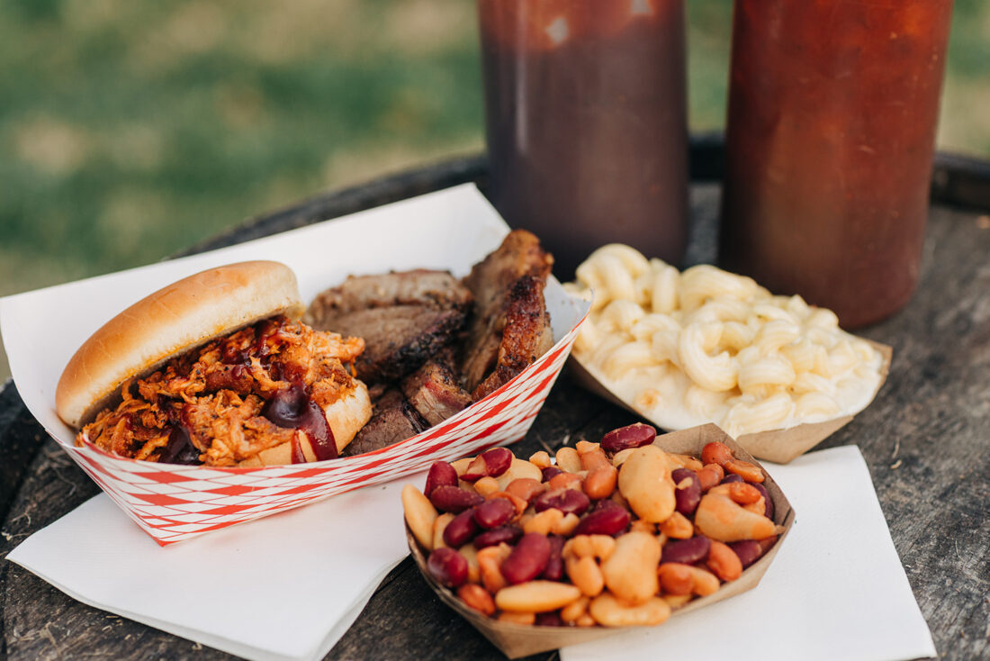 A pulled pork sandwich, brisket, smoked baked beans, and mac and cheese from 502Cafe by Four Pegs Smokehouse.
