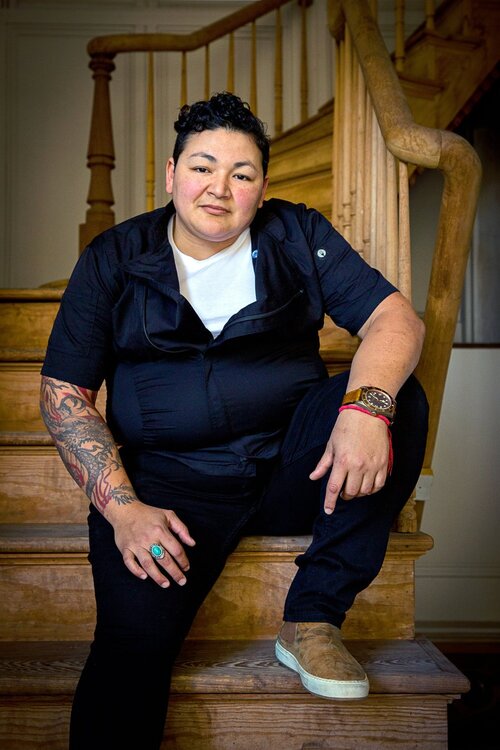 A portrait of a woman sitting on wood steps