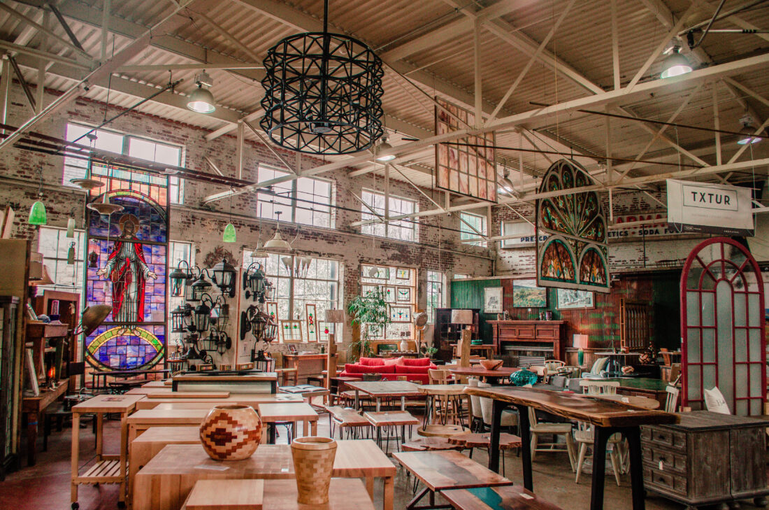 The interior of a warehouse with a variety of salvaged items