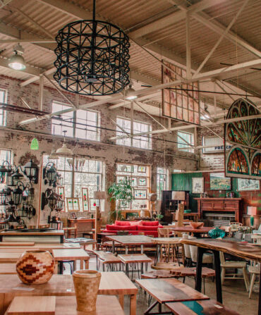 The interior of a warehouse with a variety of salvaged items