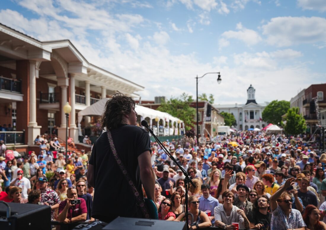 A man plays guitar for a crowd