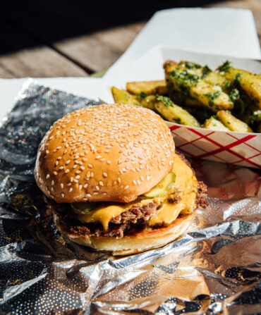 A cheeseburger on a foil wrapper