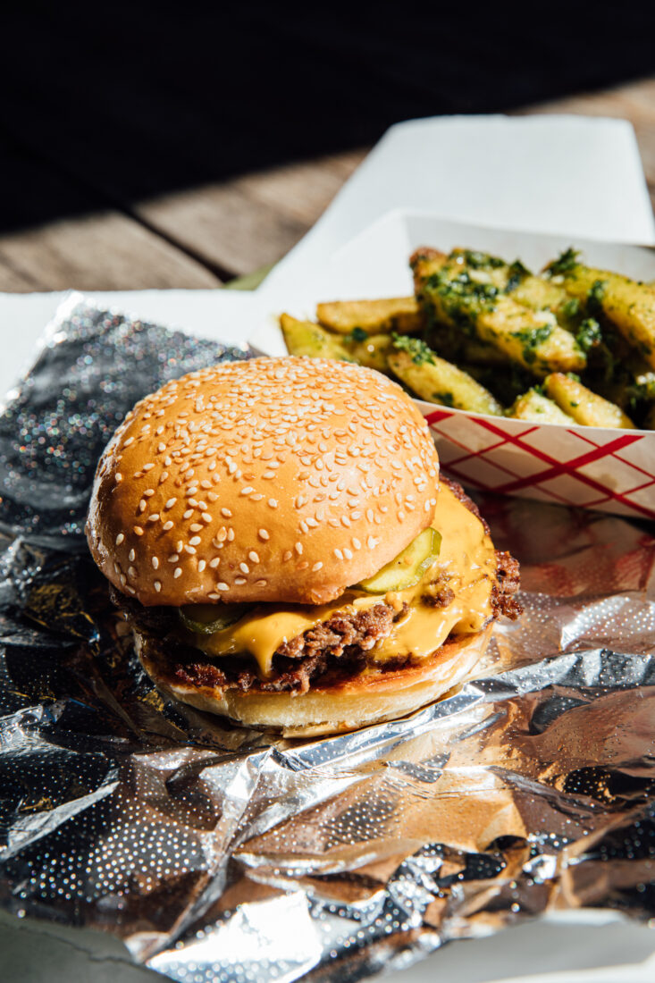 A cheeseburger on a foil wrapper