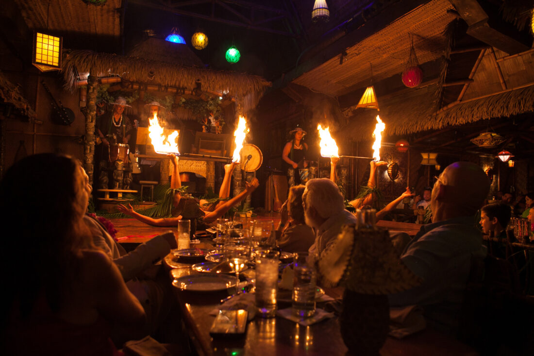 Fire dancers light up a stage in a restaurant