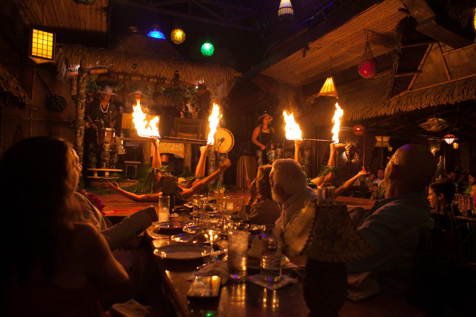 Fire dancers light up a stage in a restaurant