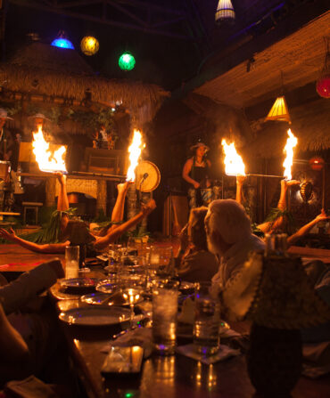 Fire dancers light up a stage in a restaurant