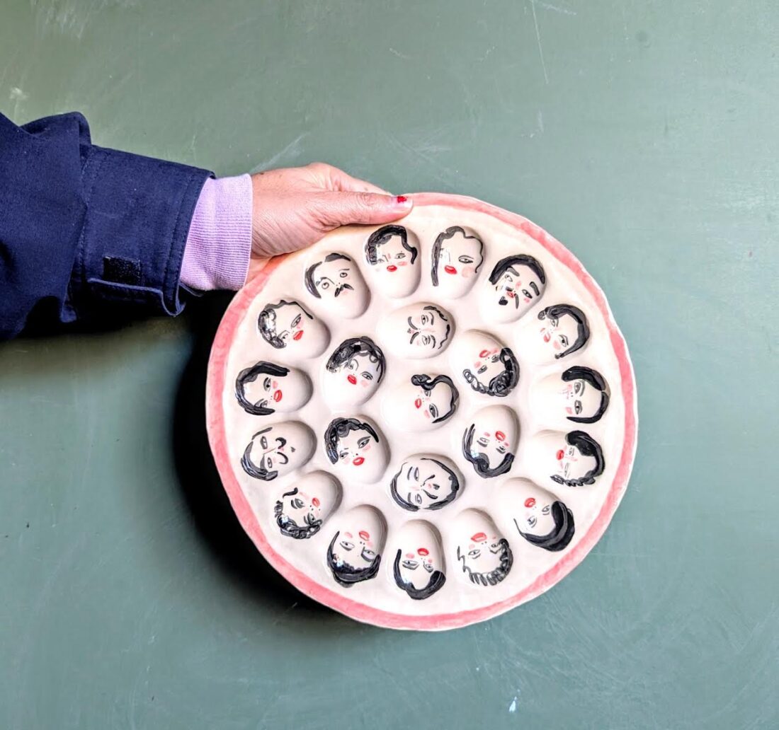 A deviled egg plate with painted faces