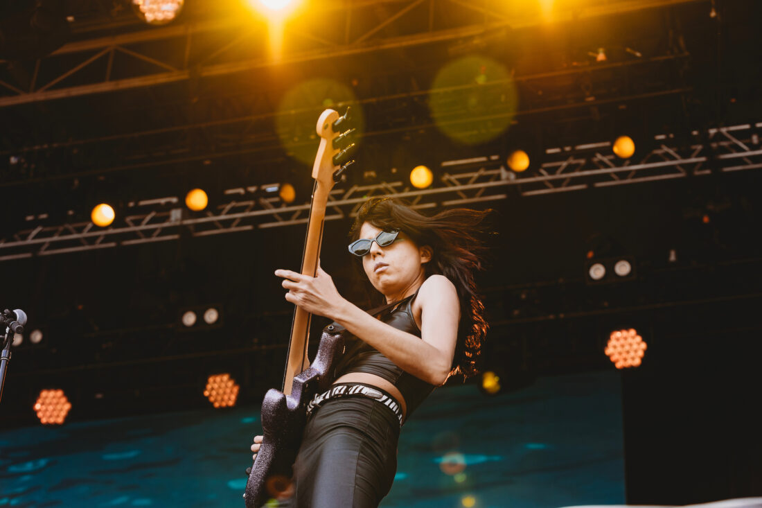 A woman playing guitar on a stage