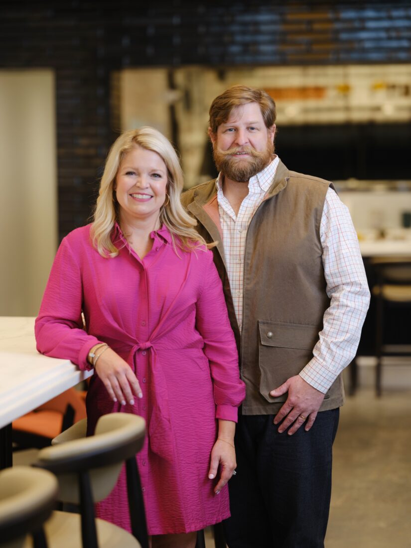 A man and woman posing for a portrait in a restaurant
