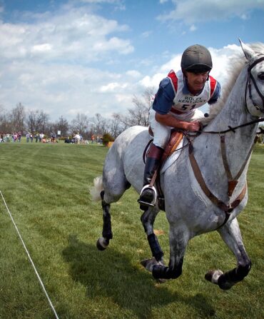 A man riding a gray horse