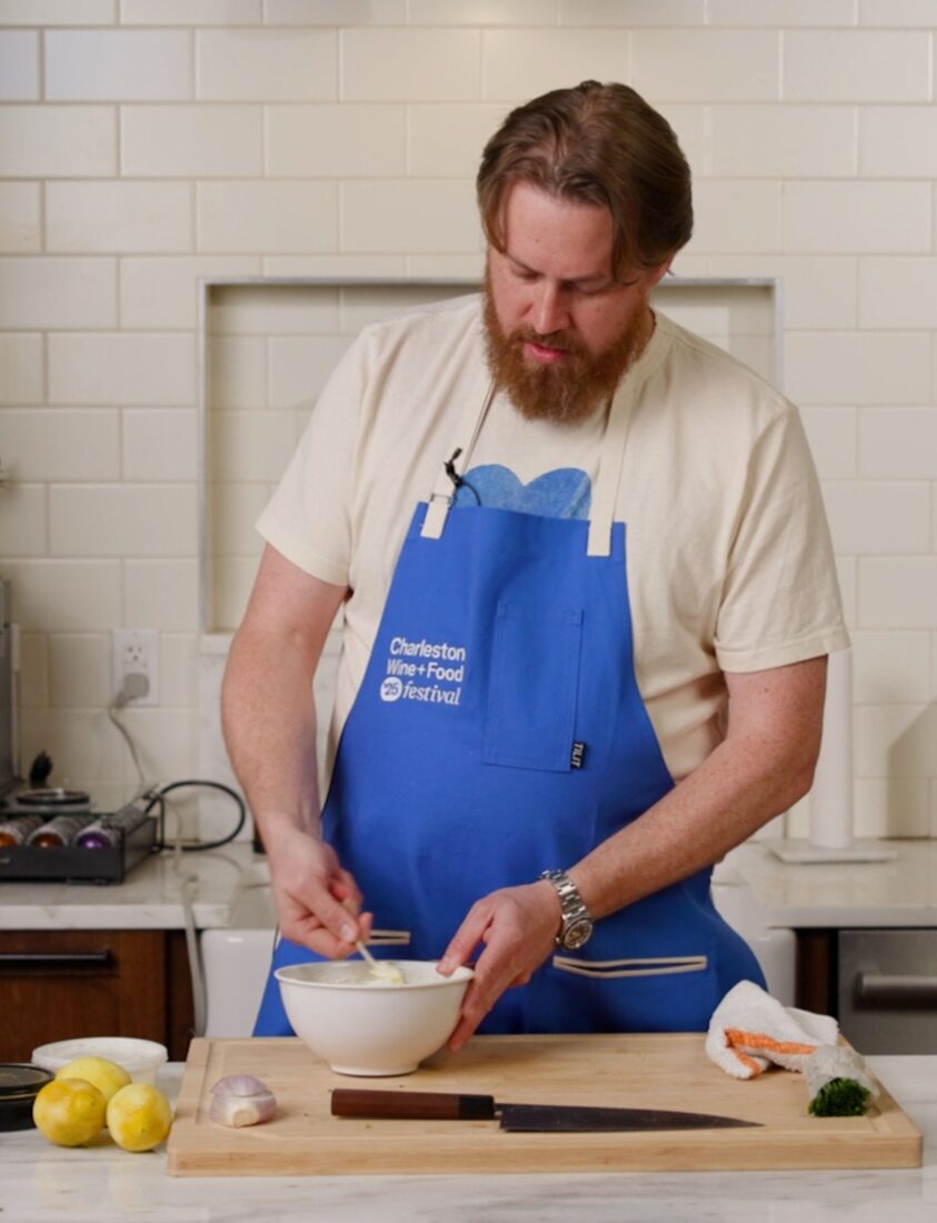 A chef preparing a dish in a kitchen