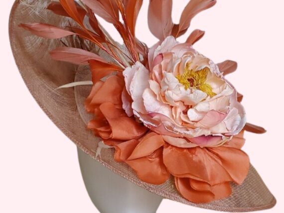 A beige hat with coral and light pink accents