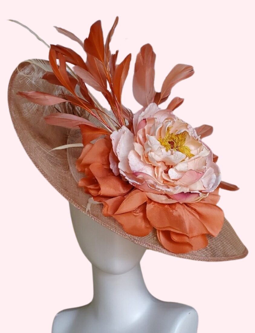 A beige hat with coral and light pink accents