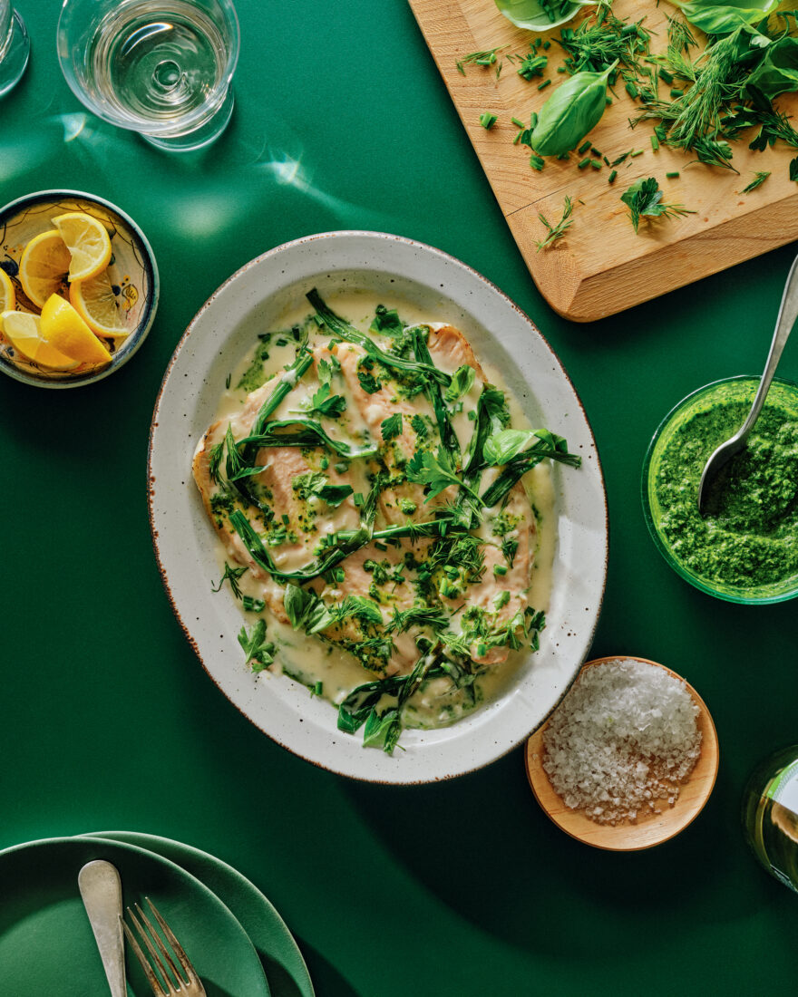 A trout dish with green garlic on top