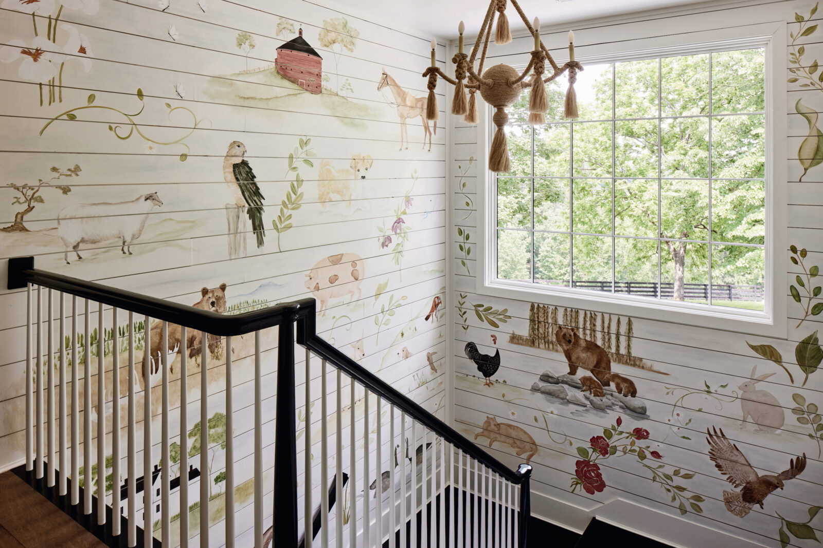 Painted flora and fauna on a white wall in a stairwell