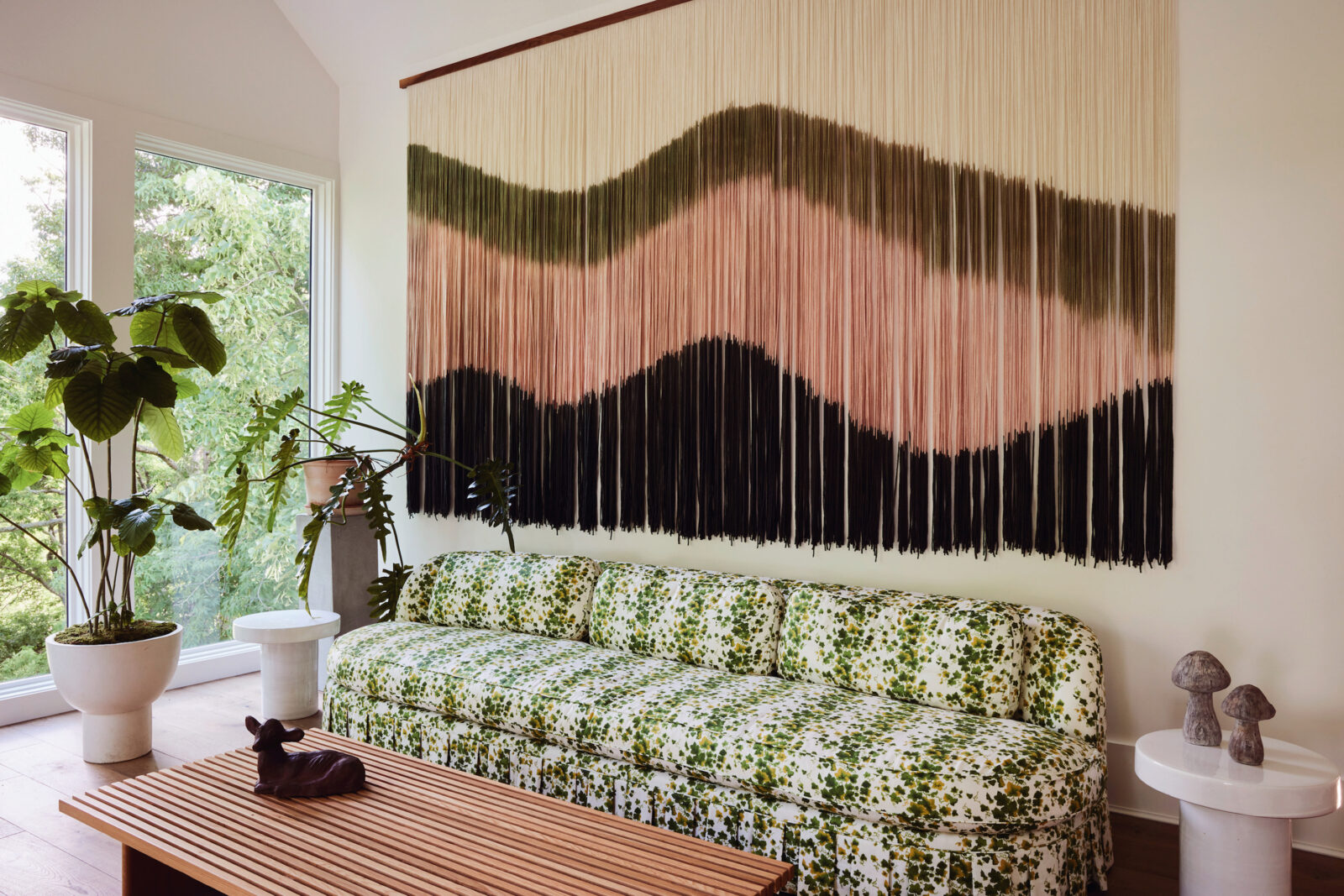 An ombre woven wall above a foliage patterned couch