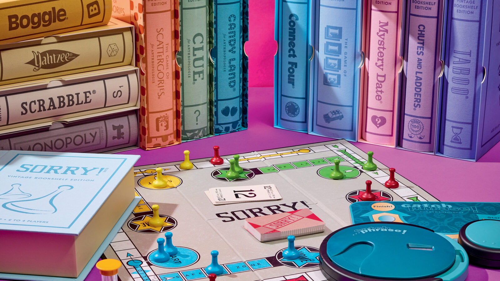 A spread of boardgames on a pink background