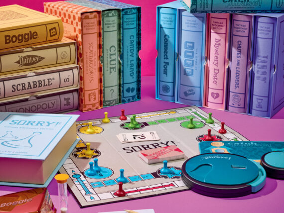 A spread of boardgames on a pink background