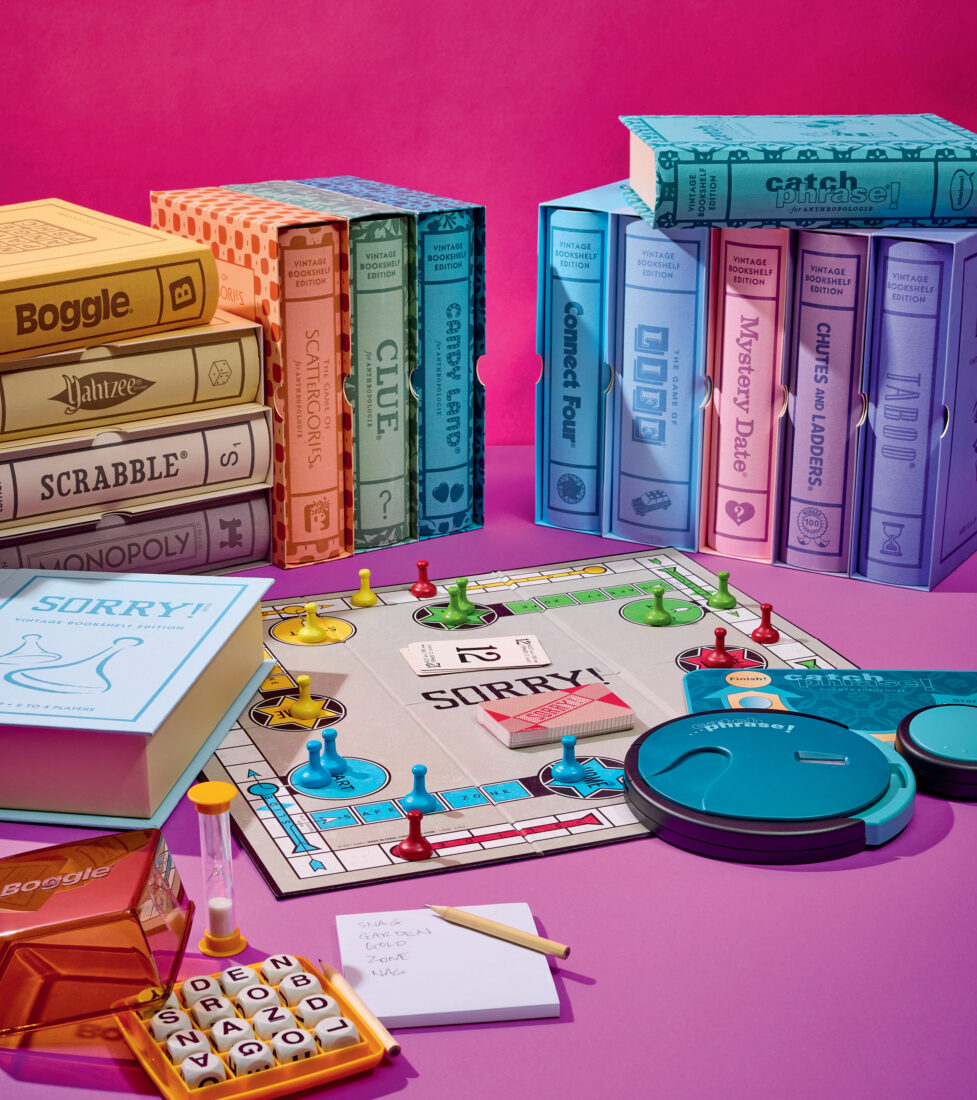 A spread of boardgames on a pink background