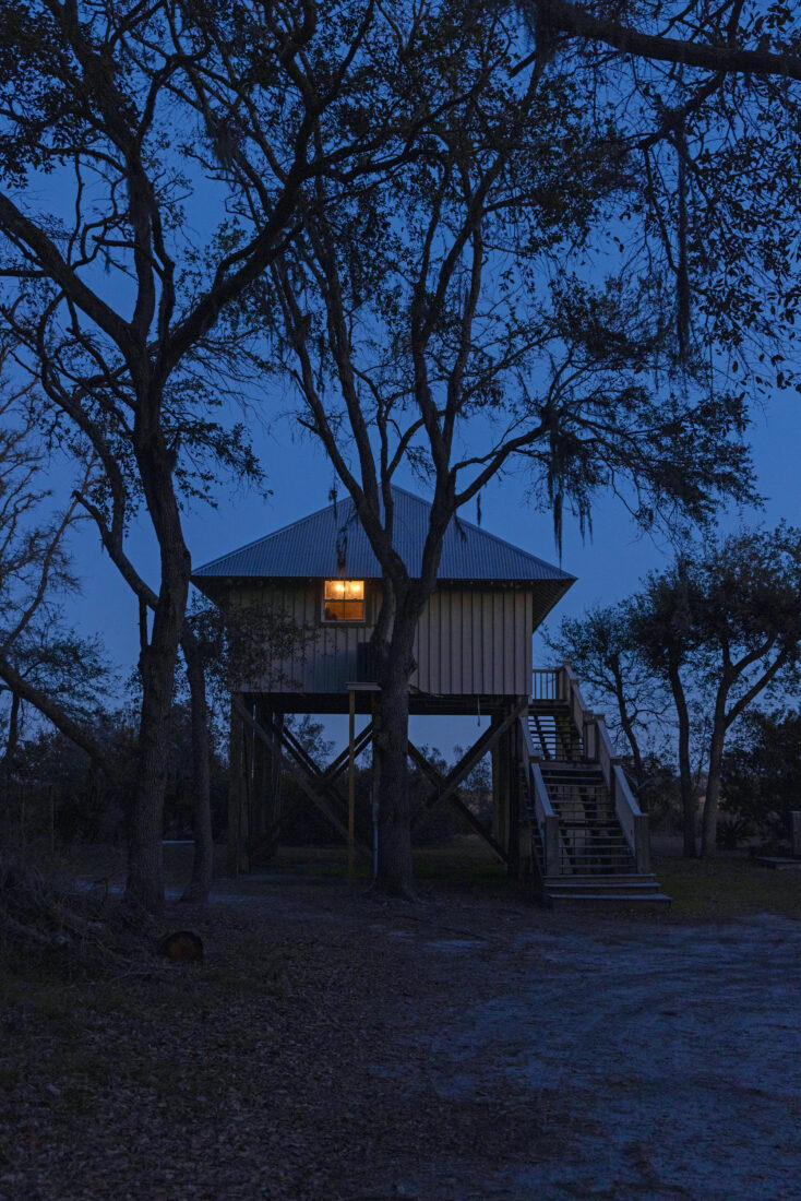A lit window of a cottage during nighttime