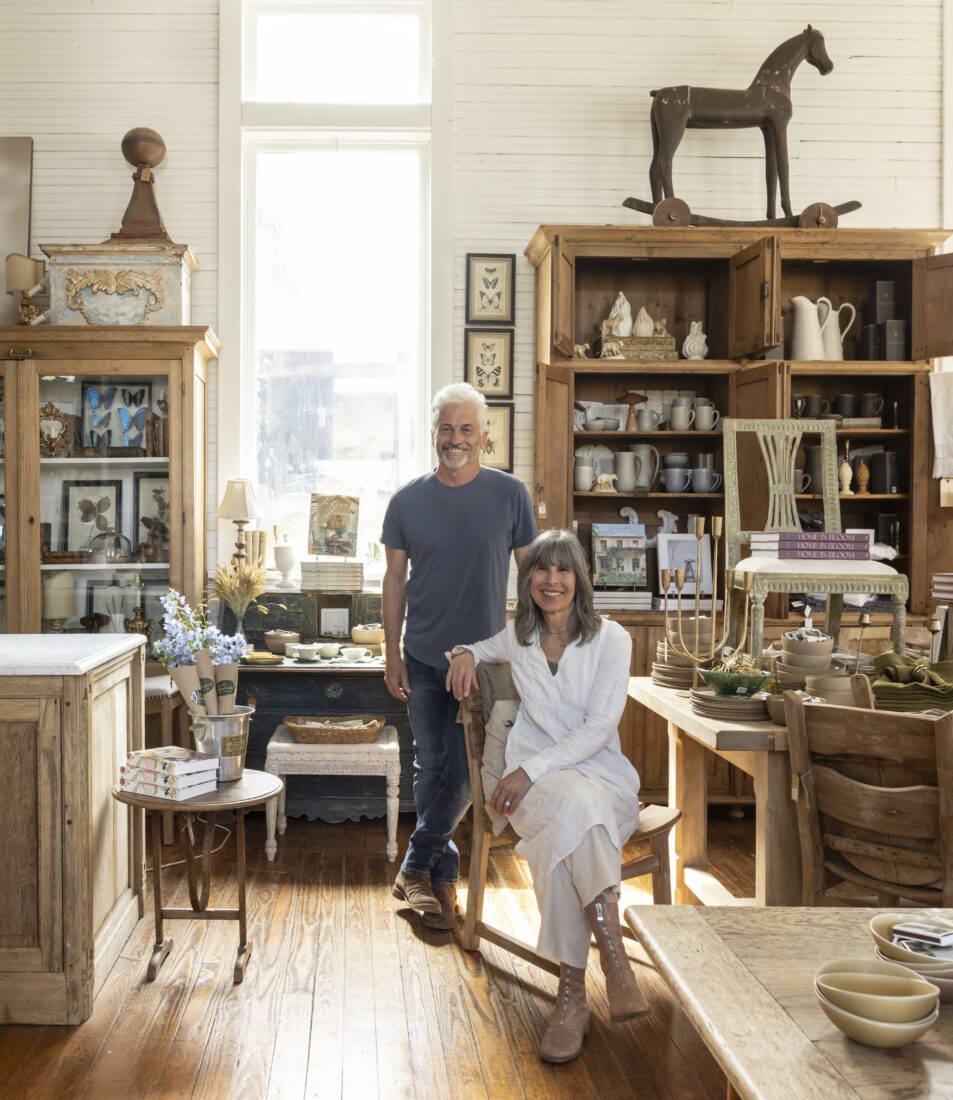 A man and woman standing in a shop stocked with home decor