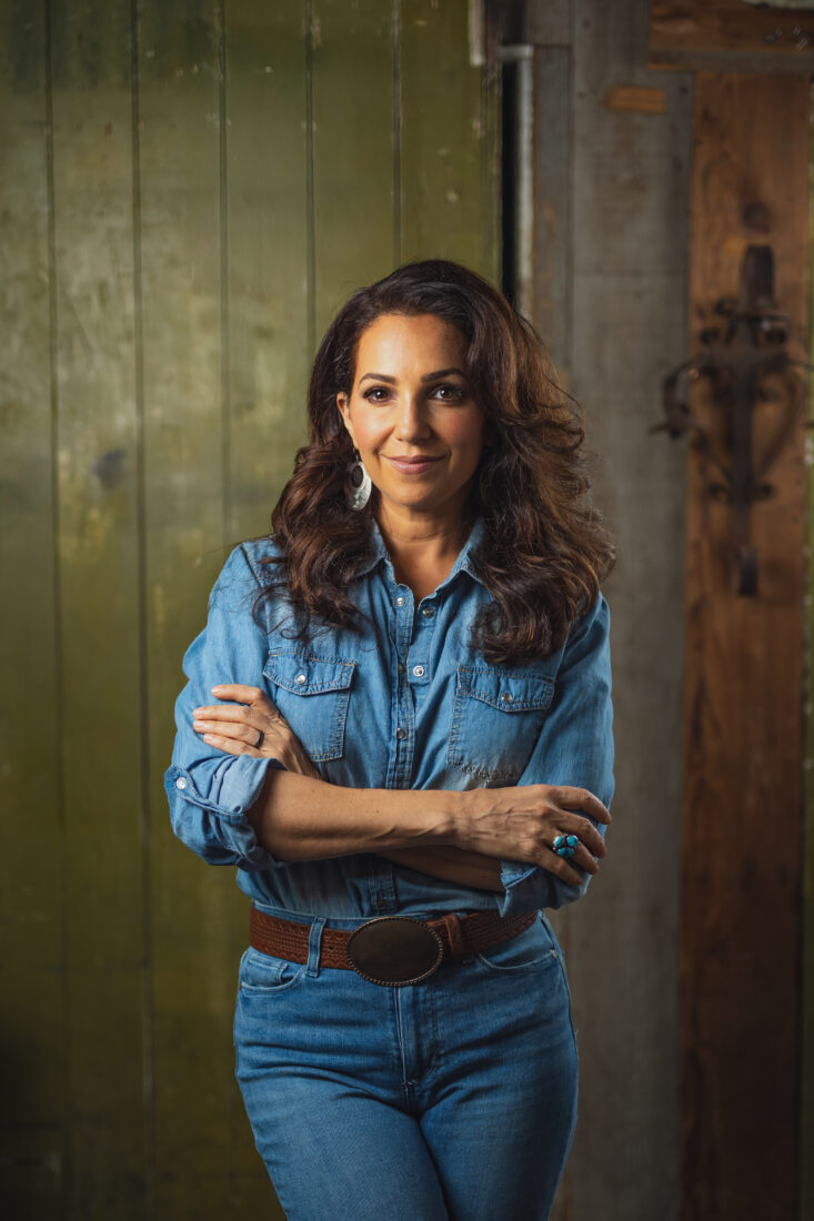 A woman wearing a denim shirt and pants
