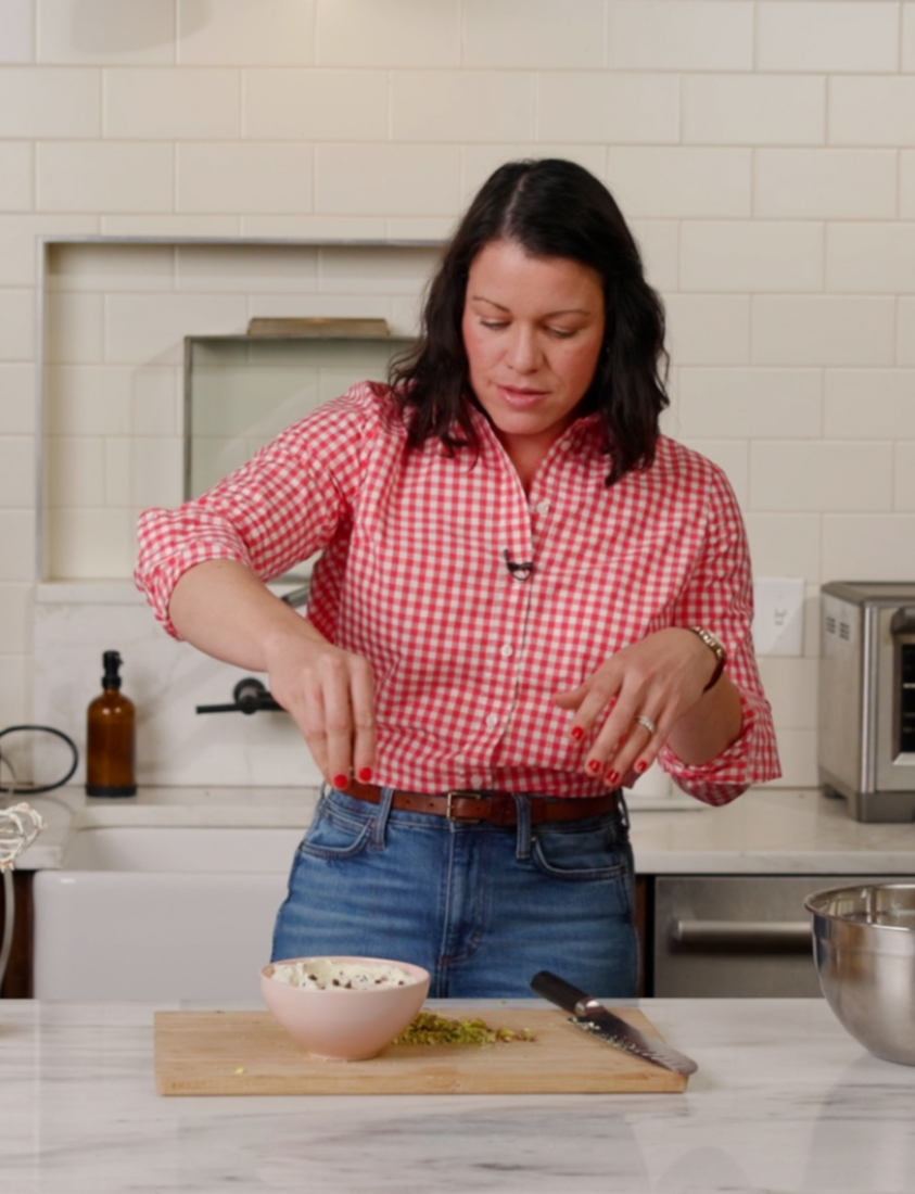A baker preparing a dish in a kitchen