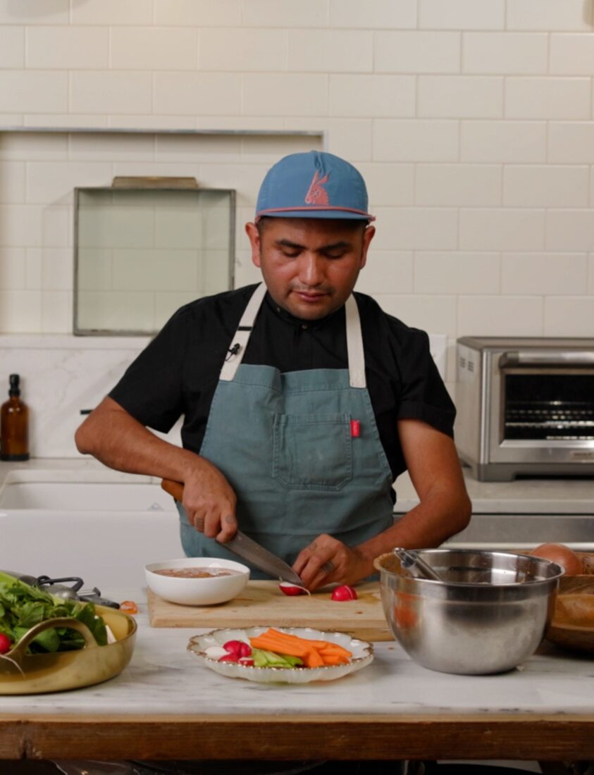 A chef preparing a dish in a kitchen