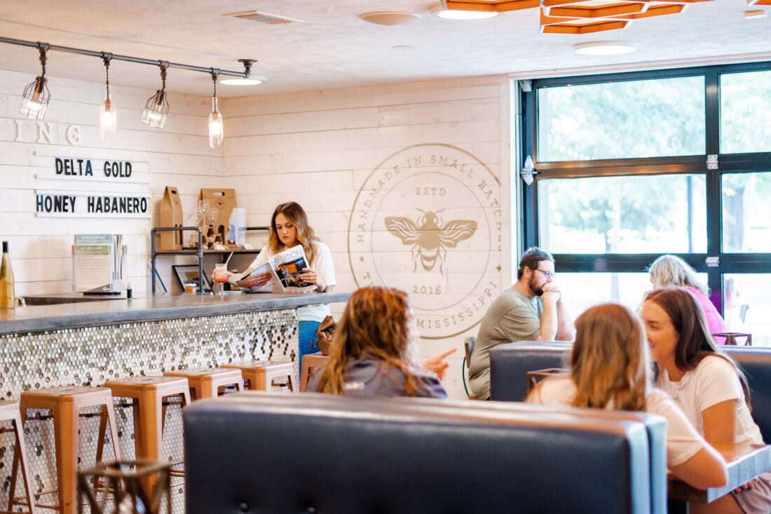 Inside a meadery shop with booths and people seated