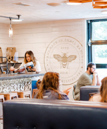 Inside a meadery shop with booths and people seated
