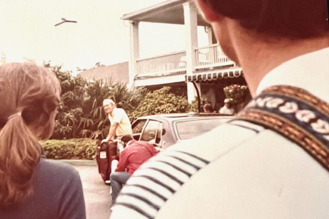 A man standing beside a Cadillac
