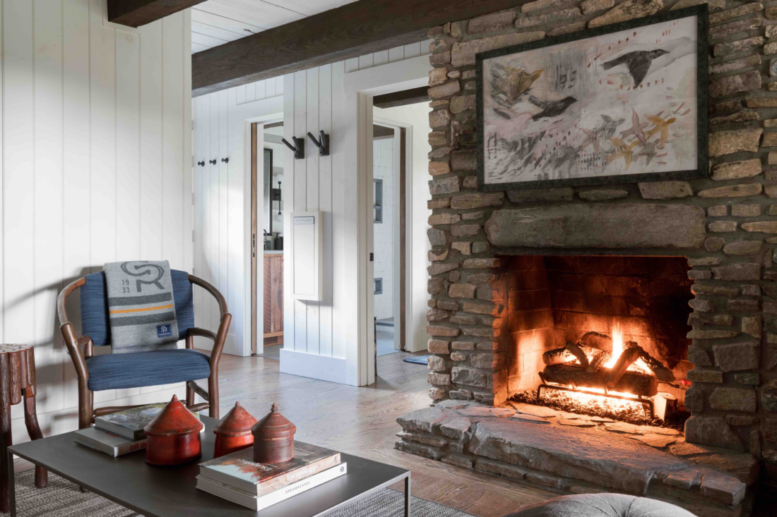 A parlor room with a fireplace