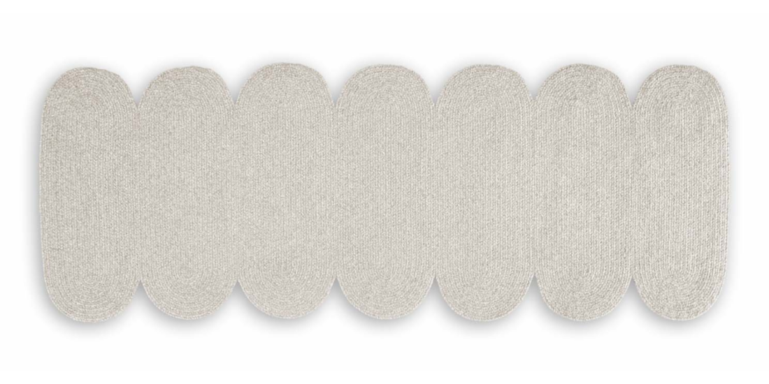 A gray rug with a scalloped border