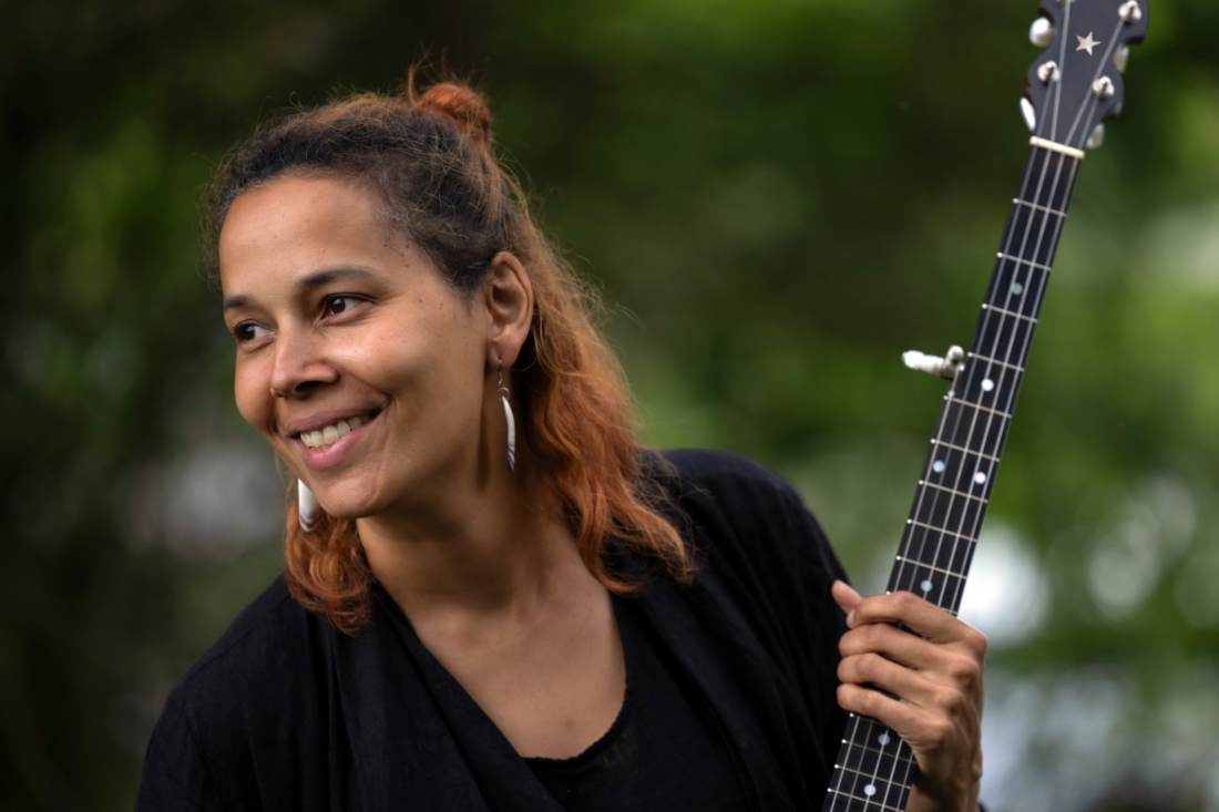A woman holding a banjo