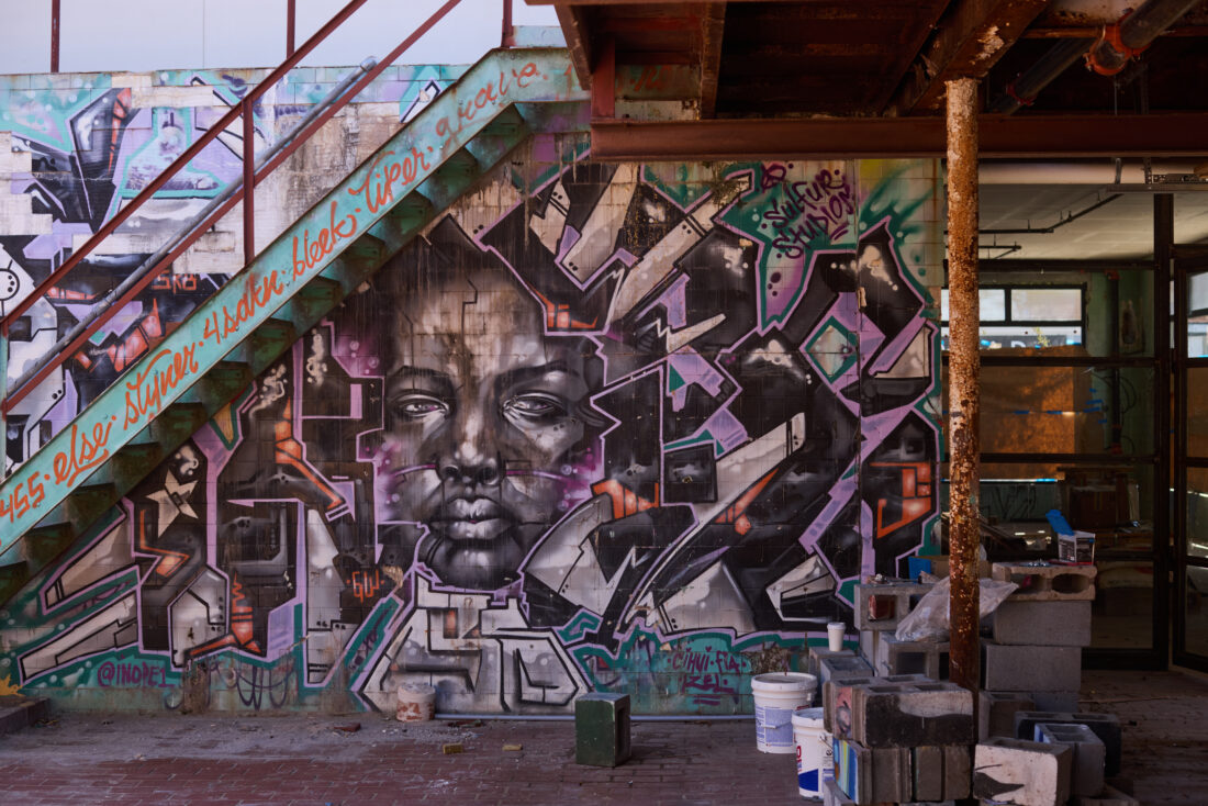 A colorful mural painted below a staircase
