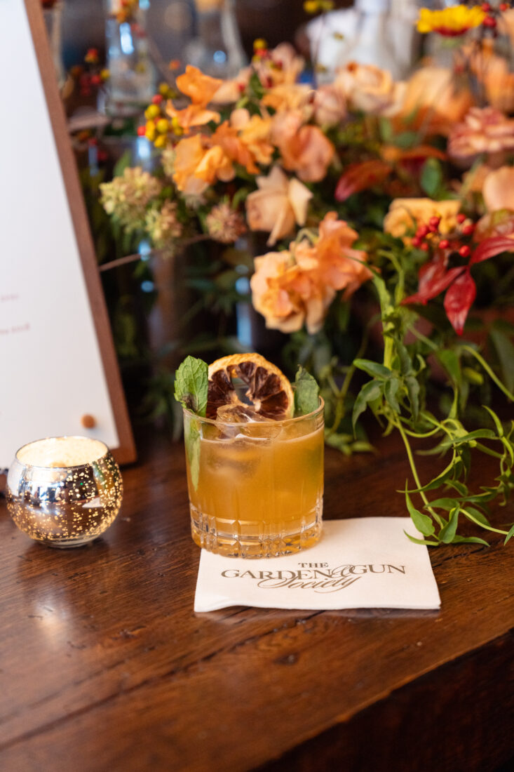 The Bee Charmer cocktail made with Asheville-based Chemist gin, Licor 43, honey simple syrup, mint, and basil.