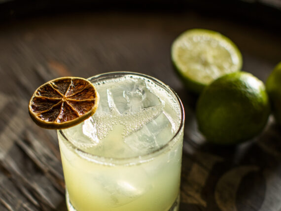 A margarita with a dehydrated lime