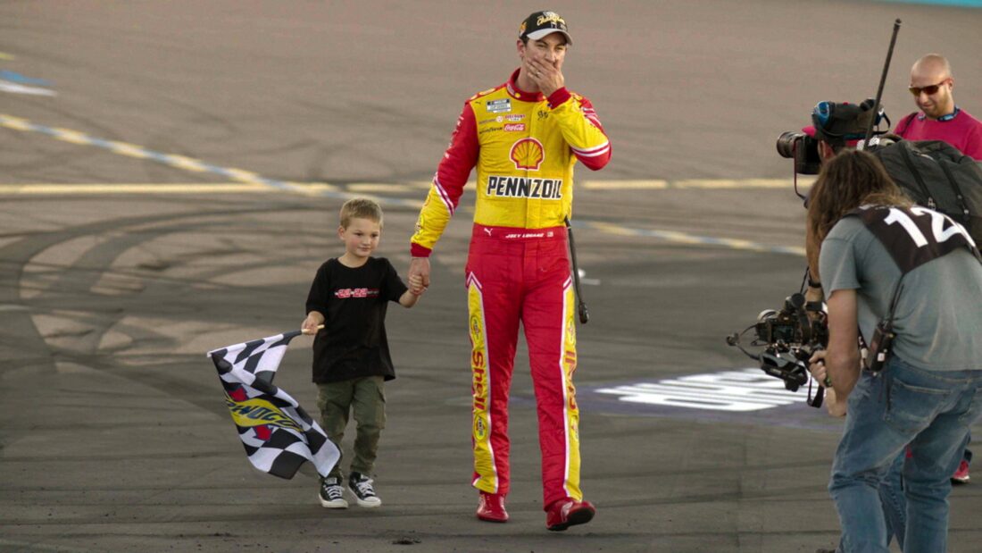A man and his son on a racetrack