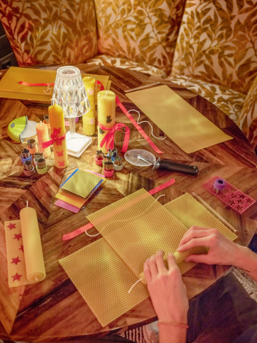 A person rolls beeswax candles