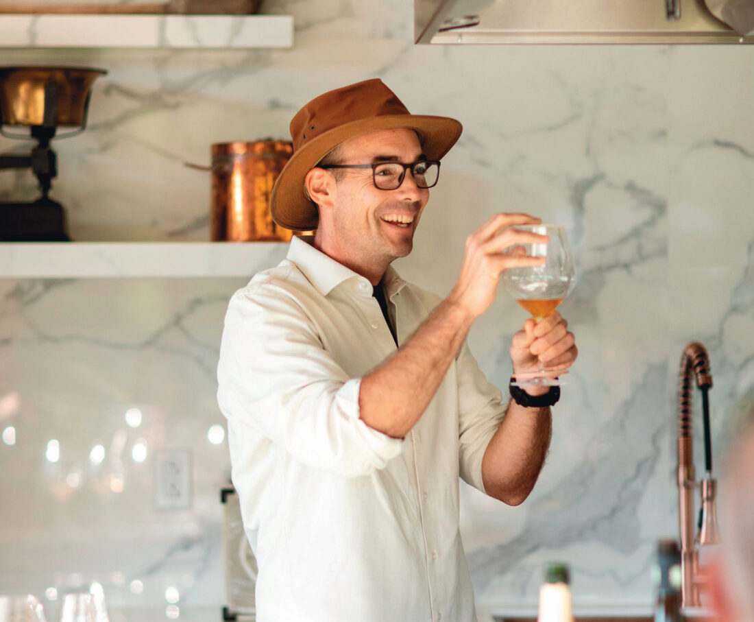 A man holds a glass of honey