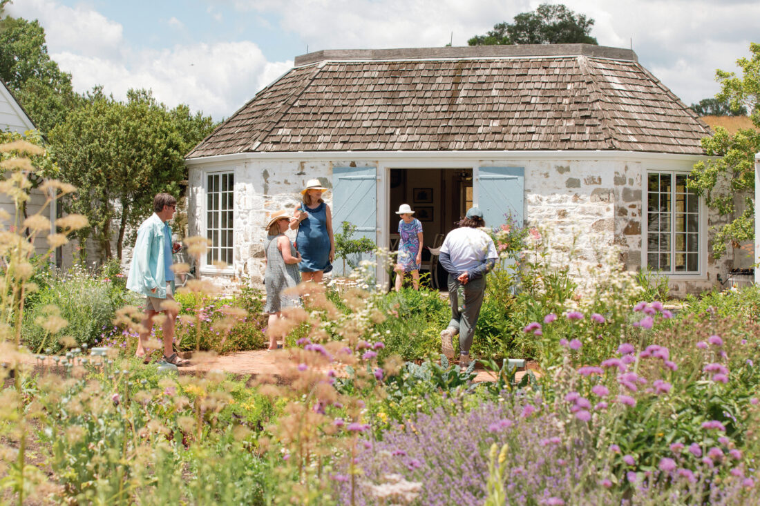 People tour a lush garden