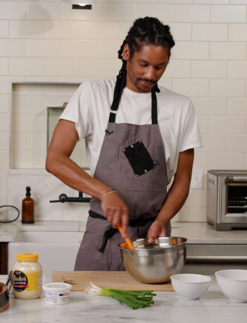 A chef preparing a dish in a kitchen