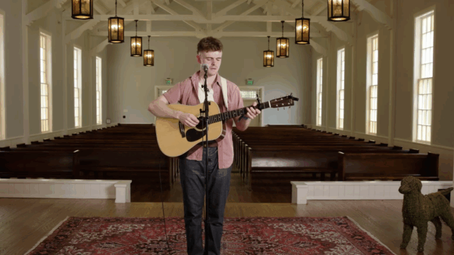 A man holds a guitar