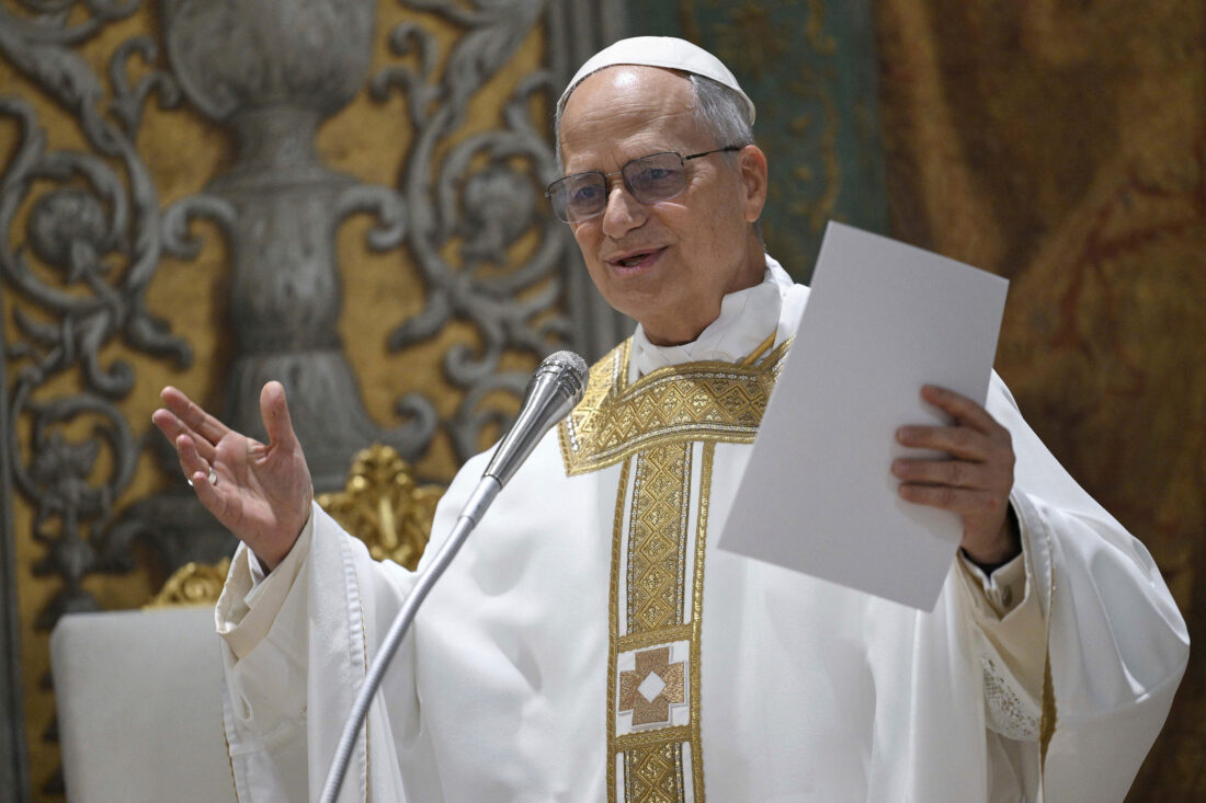 The new pope speaking at a microphone