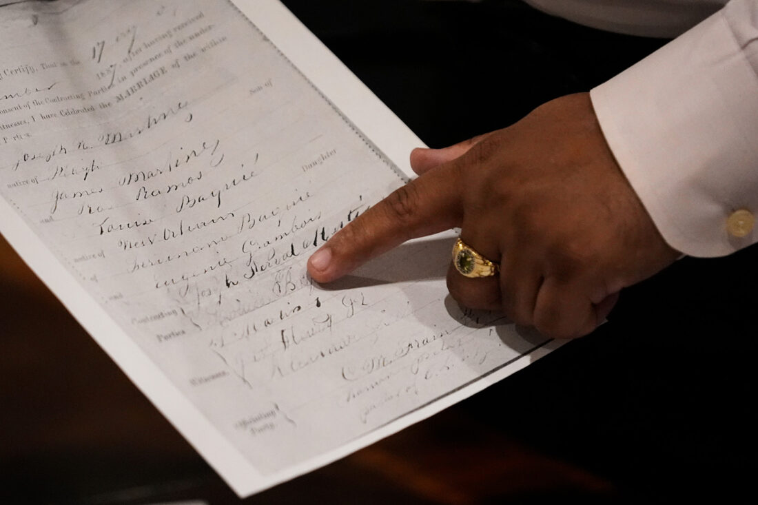A person points to an old document