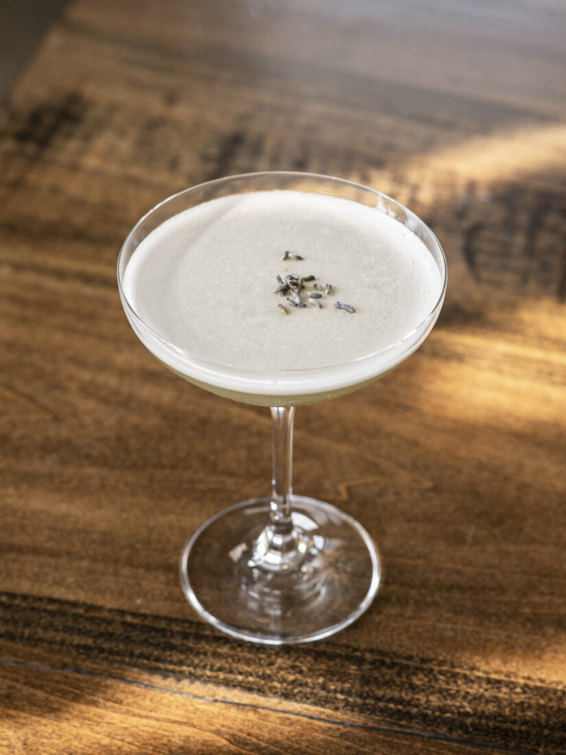 In the Holler, a cocktail composed of Shine Girl Lavender Moonshine, peach black tea, fresh lemon juice, and honey syrup.