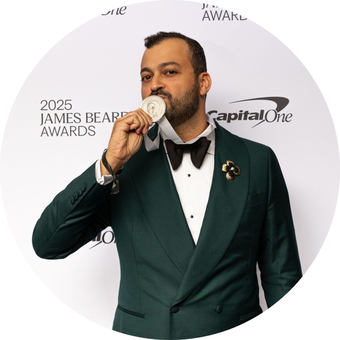 A portrait of a man kissing a medal