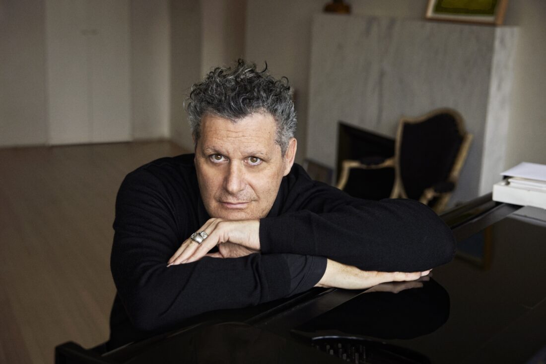A portrait of a man with curly grey hair